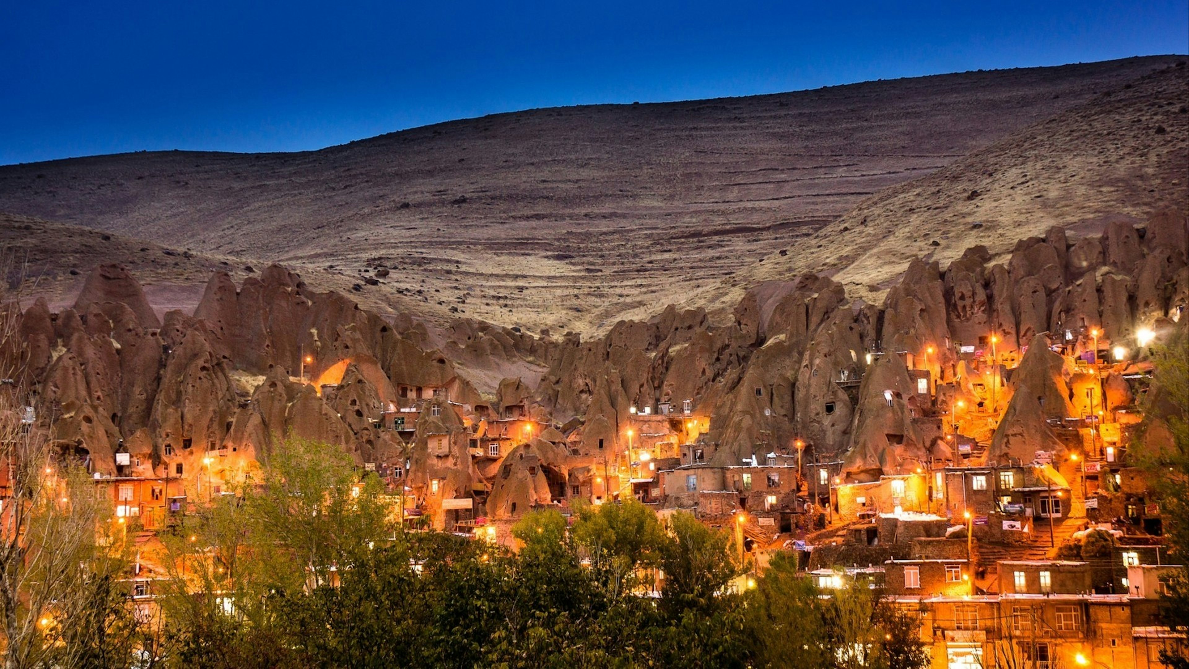 Cityscape image of Kandovan village during twilight blue hour a tourist destination of troglodyte dwellings in East Azarbaijan