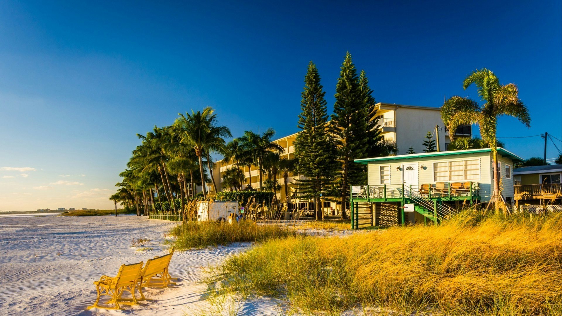Sand dunes and buildings on the beach in Fort Myers Beach, Florida.
