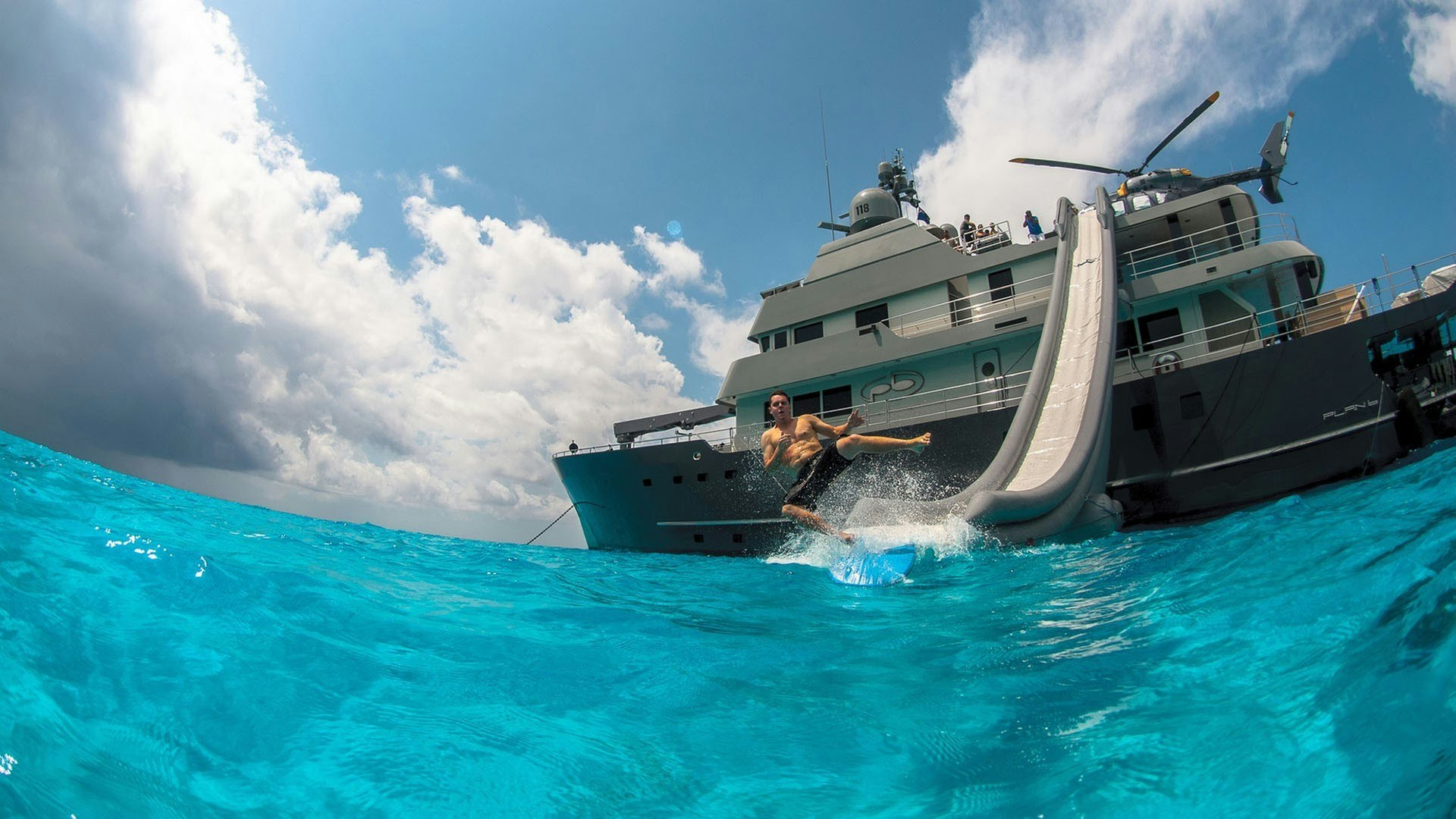 Freestyle slide off the side of motor yacht