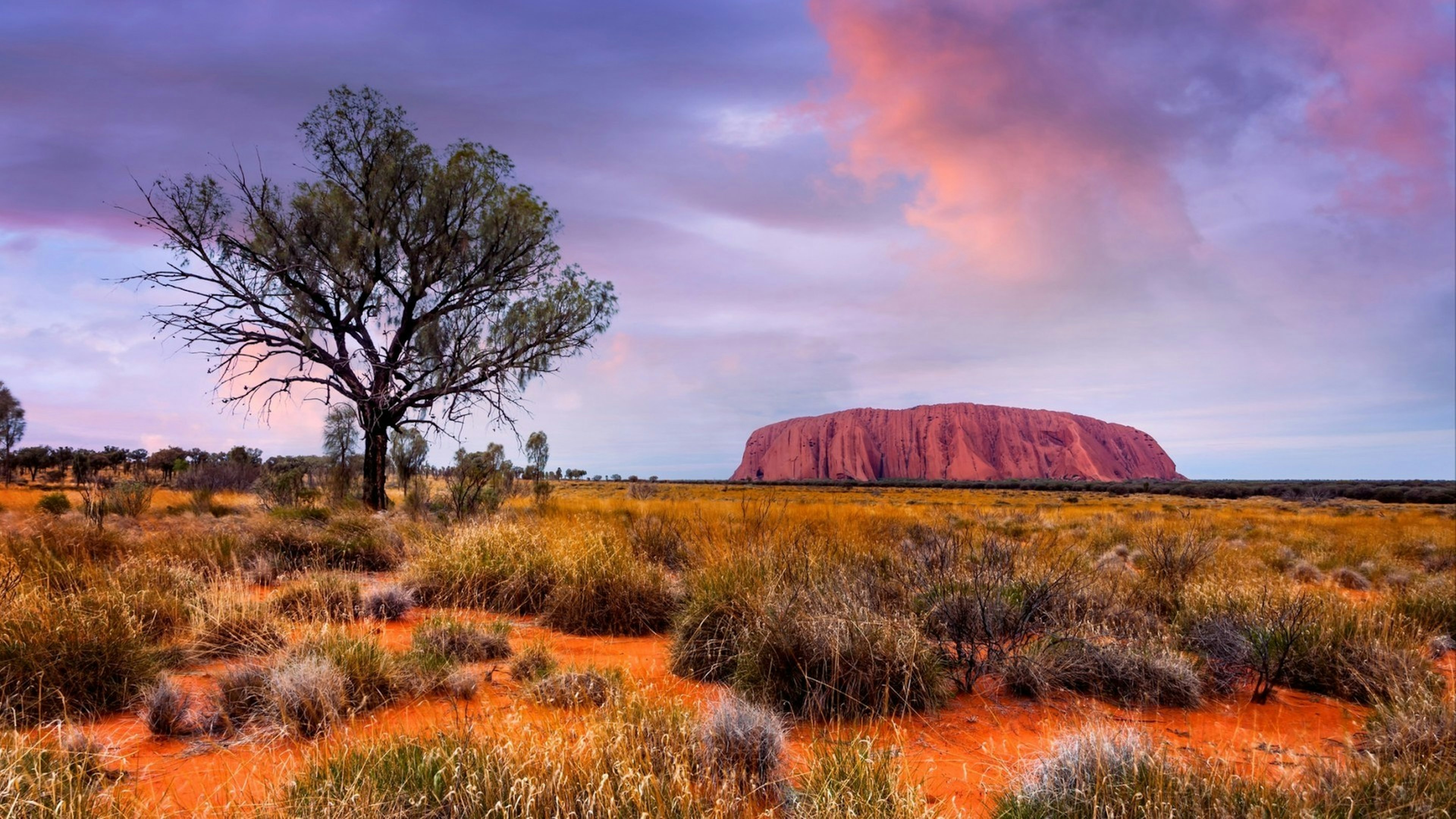 Uluru (Ayer's Rock) in Uluru-Kata Tjuta National Park is a massive sandstone monolith in the heart of the Northern Territory’s arid  Red Centre