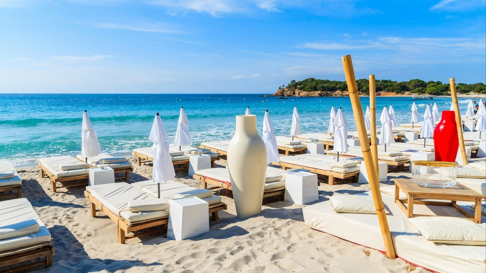 Rows of sunbeds on famous white sand Palombaggia beach, Corsica island, France