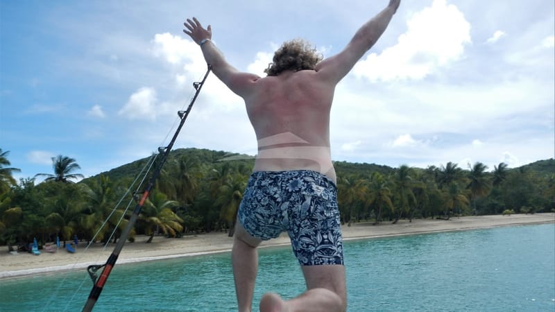 GENESIS charter guest jumping in water