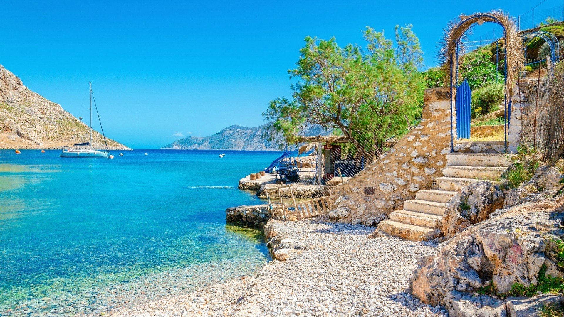 Stairs from sandy beach of amazing bay on Greece island Kalymnos, Greece