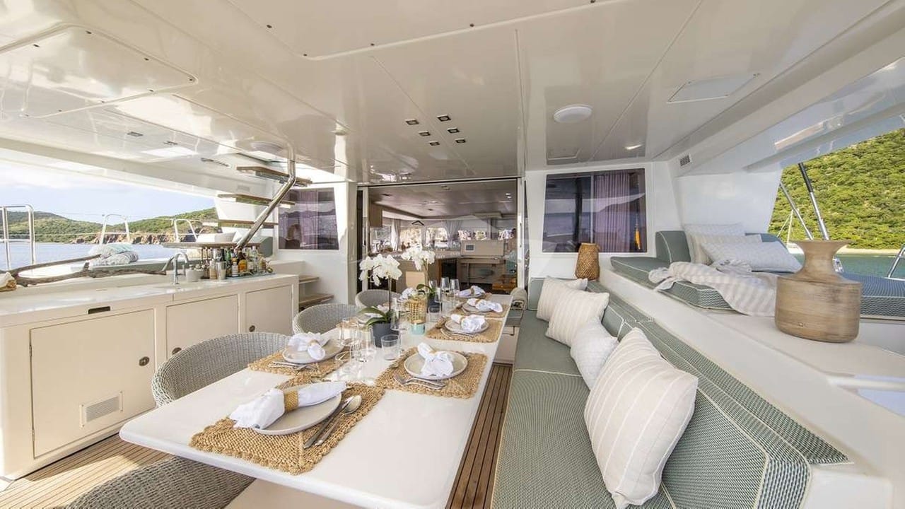 Stylish aft deck dining area comfortably seats up to 10 guests.