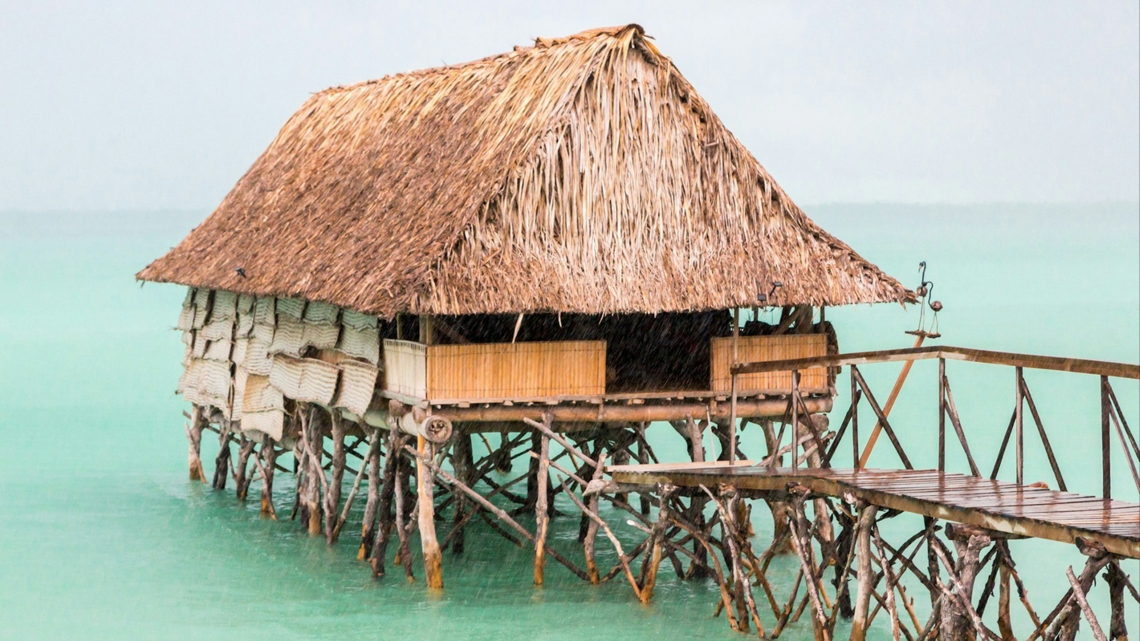 Traditional authentic over water thatched roof bungalow of native local aborigines Micronesian people