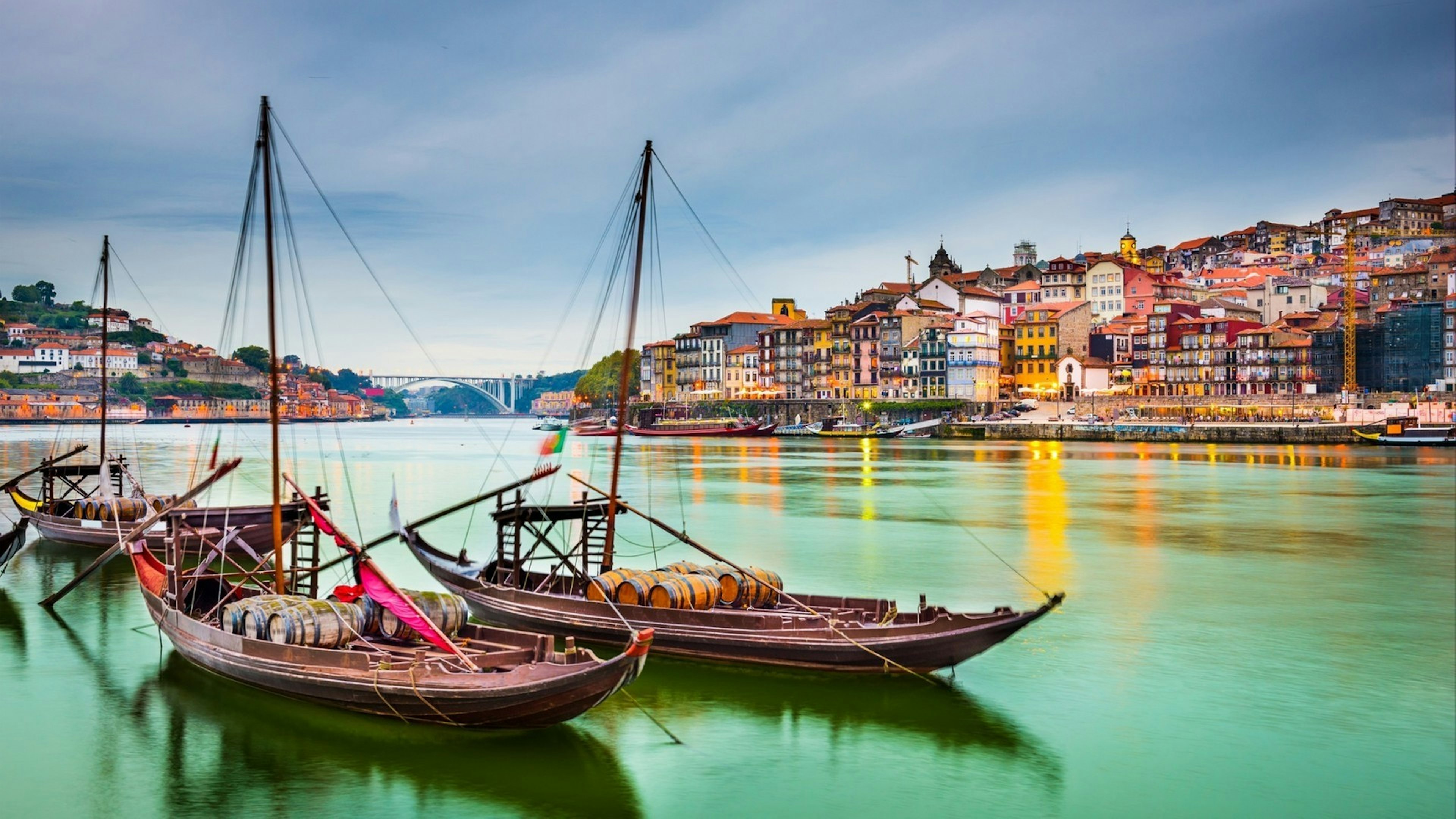 Portugal old town cityscape on the Douro River with traditional Rabelo boats.