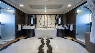 Master en suite with large bath, and his and her showers and sinks