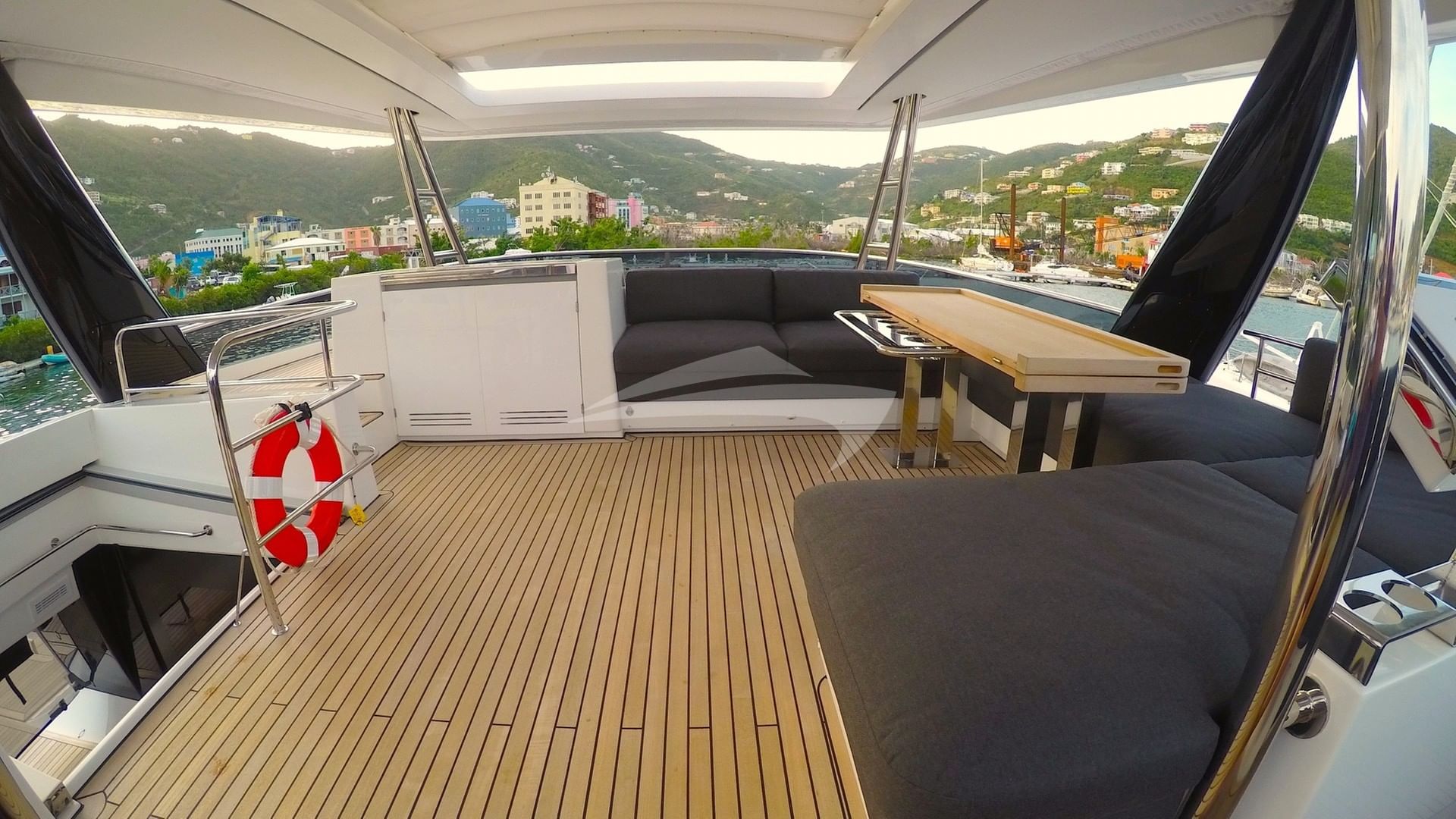 Spacious flybridge deck and lounging area.