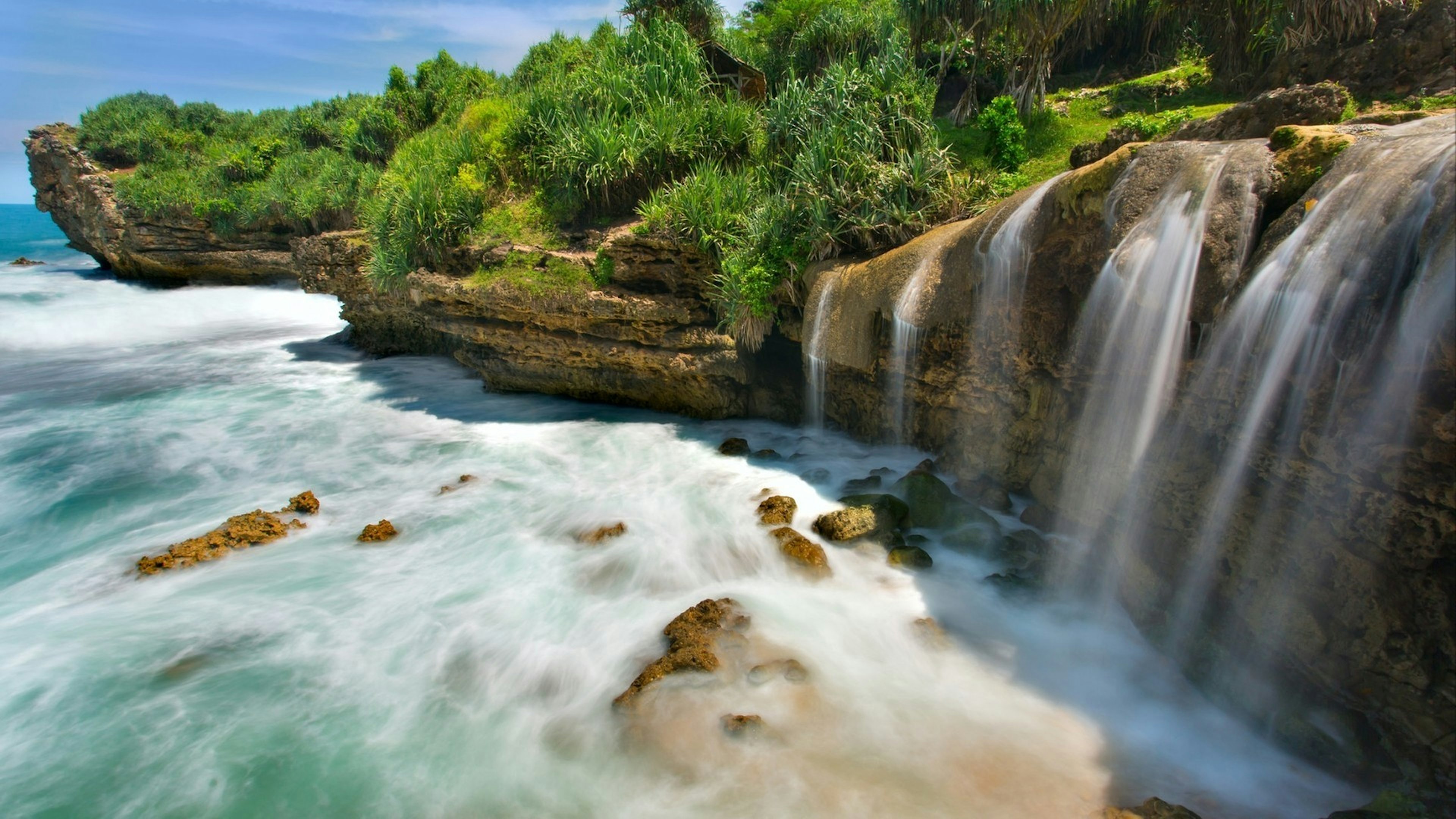 Beautiful Jogan waterfall falling to the ocean, Java, Indonesia