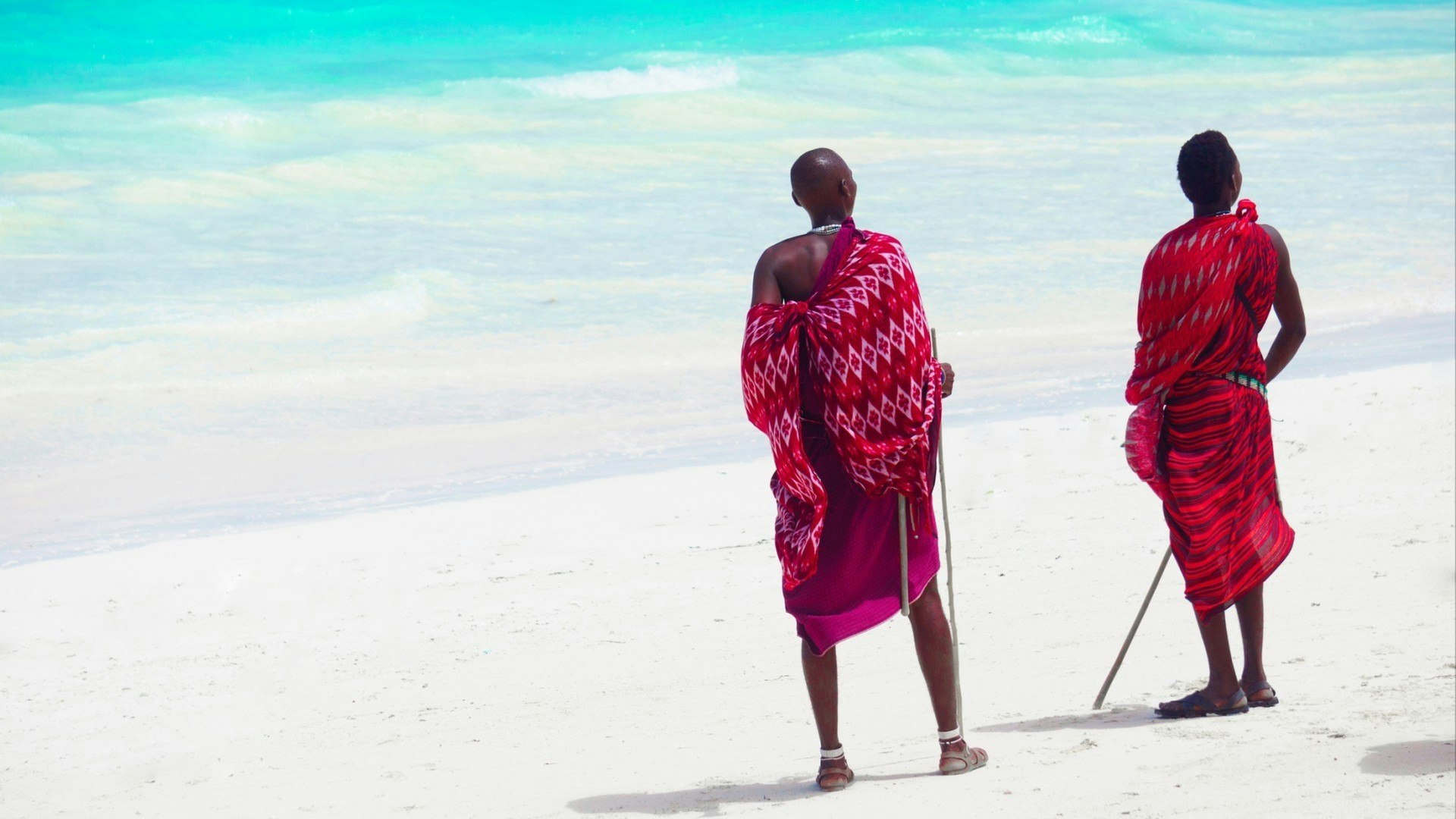 Three masai tribe member standing near the ocean in Zanzibar