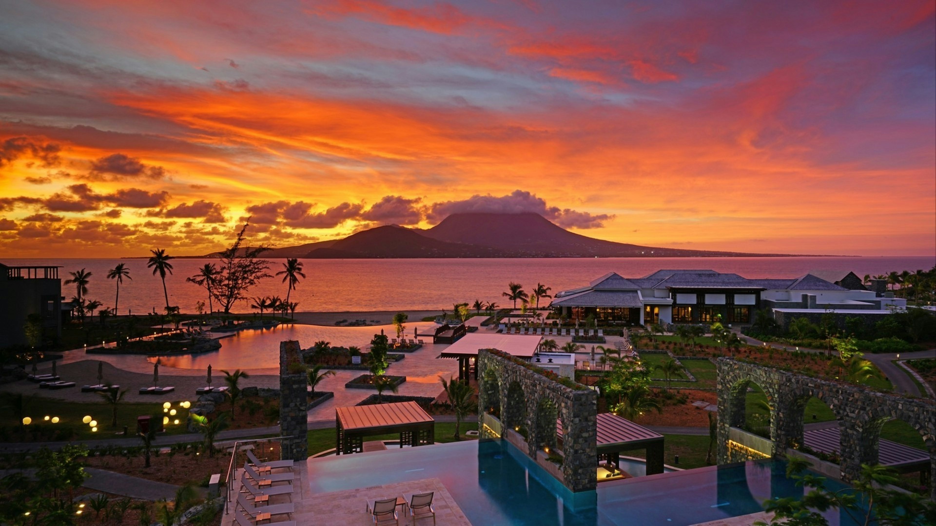 Dramatic orange sunrise over the Park Hyatt St Kitts, a luxury upscale hotel resort in Christopher Harbor, Saint Kitts