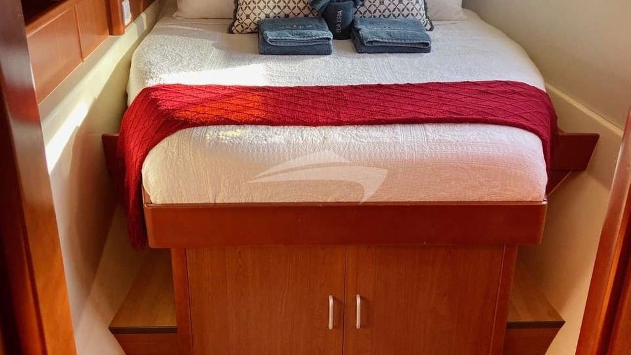 Lower level guest stateroom with opening hatch and port light for ocean breezes.